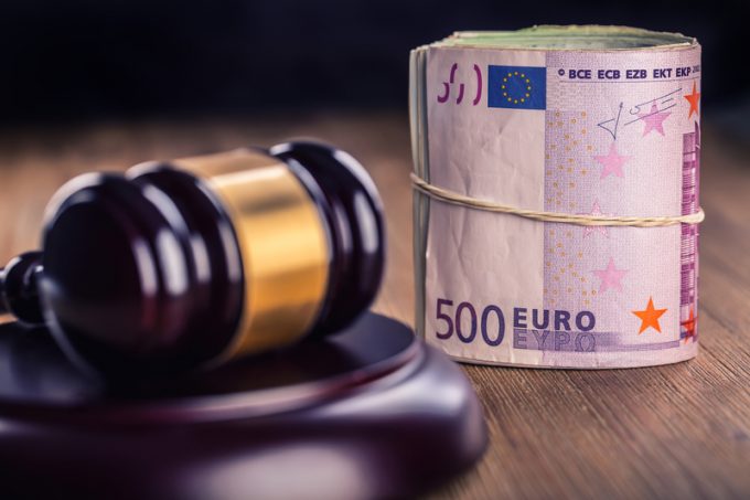 Justice and euro money. Euro currency. Court gavel and rolled Euro banknotes. Representation of corruption and bribery in the judiciary.