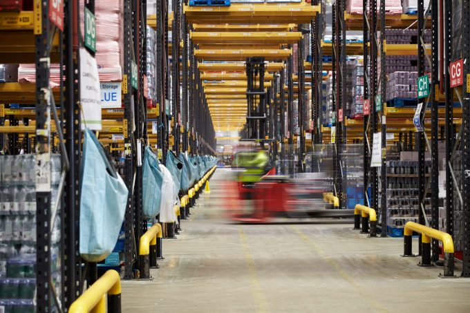 Forklift,Driving,Across,An,Aisle,In,A,Warehouse,,Motion,Blur