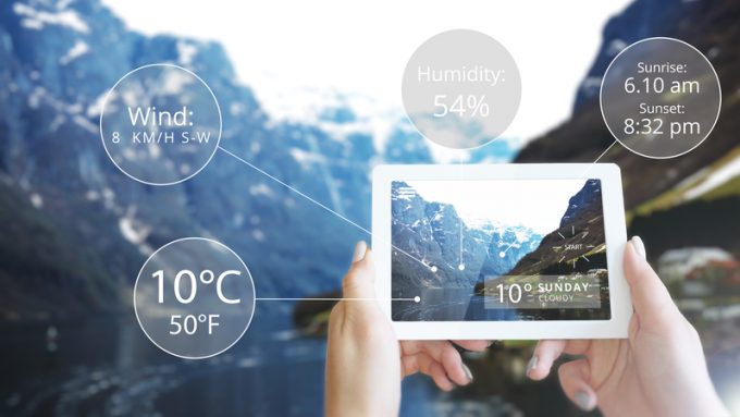 Augmented Reality information technology displayed tablet in mountain - Weather