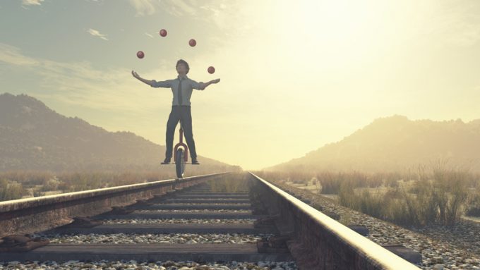 Juggler is balancing on railroad