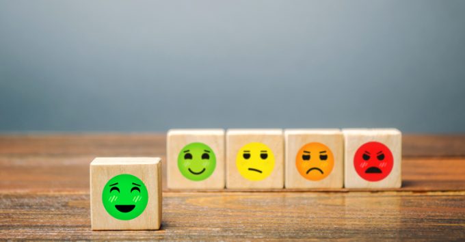 A series of blocks with faces from happy to angry. Happiness face selected. Concept of good rating, review and feedback. Satisfied customers and positive reviews, high popularity and attractiveness.