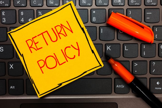 Writing note showing Return Policy. Business photo showcasing Tax Reimbursement Retail Terms and Conditions on Purchase Yellow paper keyboard Inspiration communicate ideas orange markers.