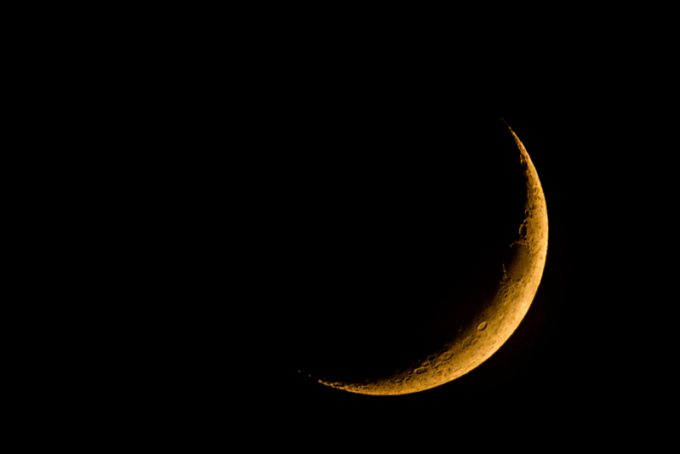 new moon on dark sky