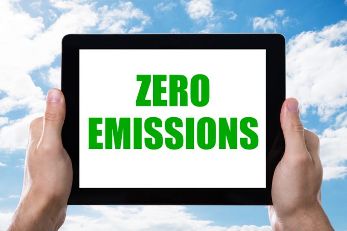 Man Holding Digital Tablet With Zero Emissions Text On Screen