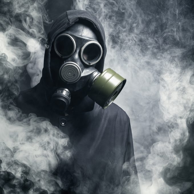 A man in a gas mask in the smoke