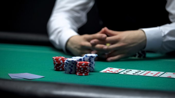 Casino client poker player making bet with all chips, chance to win at gambling