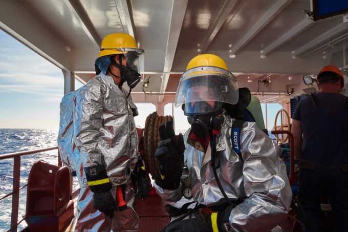 At sea - September 2018: International ship's crew performing monthly fire drill exercise.
