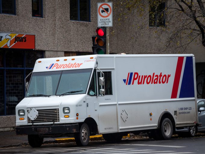 MONTREAL, CANADA - NOVEMBER 6, 2018: Purolator logo on one of their delivery trucks in a street of Montreal, Quebec. Purolator is a Canadian courier specialized in parcels and letters shipping
