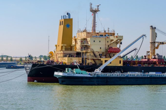 Seagoing ship bunkering fuel from inland tanker in Rotterdam har