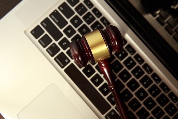 Online auction concept. Auction or judge gavel on a computer keyboard. Judge hammer on laptop computer