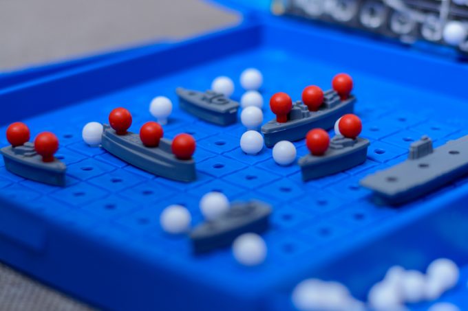 Game-battleship closeup. Toy warships and submarine are placed on the playing field. concept-strategy, thinking, victory, defeat