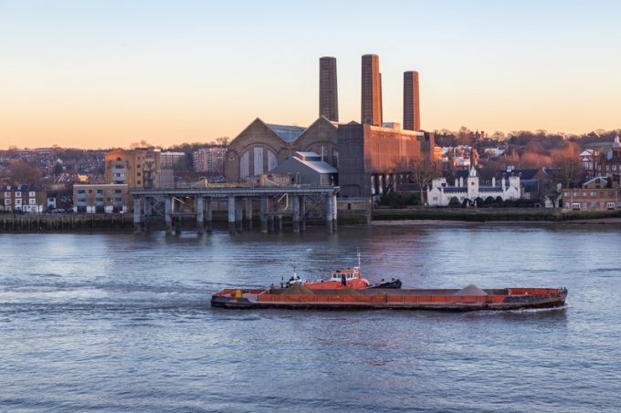 Cargo ship on the River Thames at the Greenwich power station.