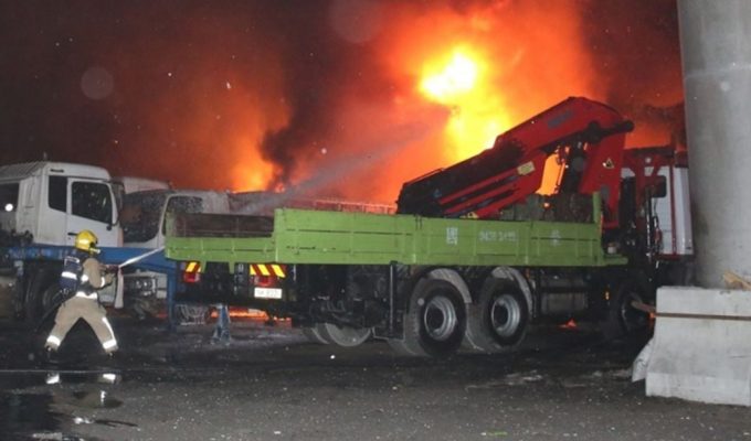 Firefighters extinguishing the flames on the container trucks 25 April 2022 – credit Julian Law