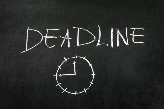 Deadline and clock drawed on blackboard with chalk