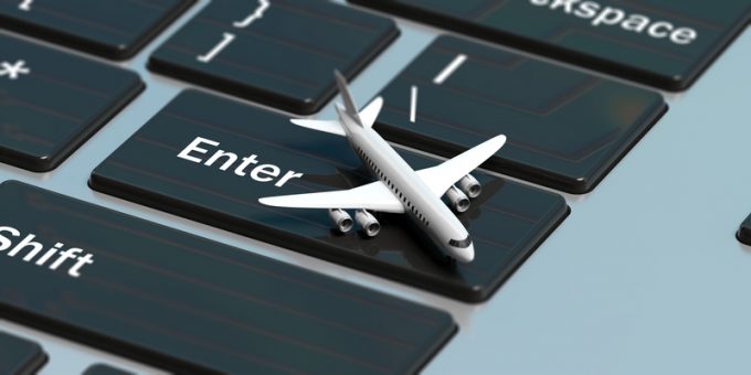 Online booking. Airplane on a computer keyboard, above view. 3d illustration