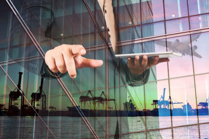 Double Exposure of Businessman with Digital Tablet and Port Carg
