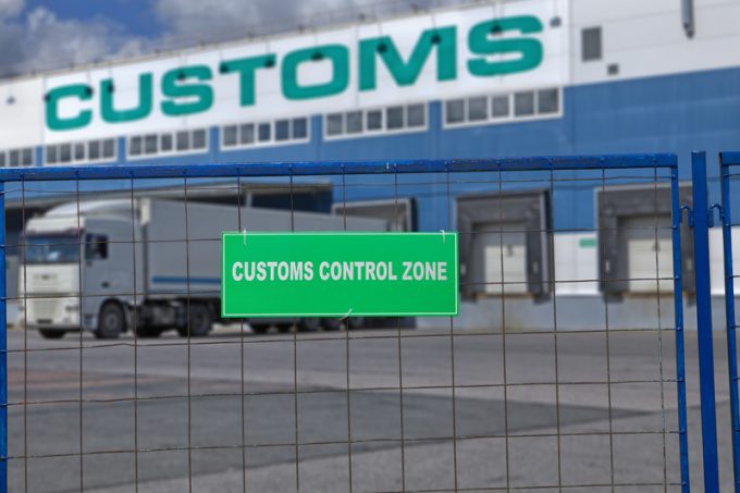 Customs control space with truck near warehouse storage of goods