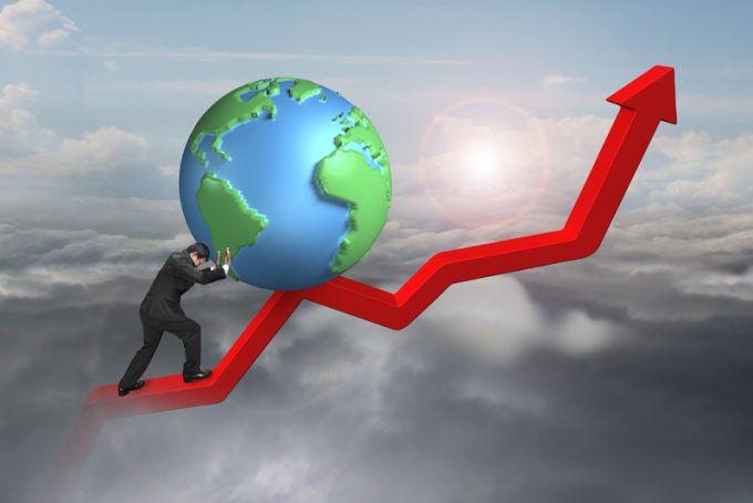 businessman pushing globe upward at starting point of trend line