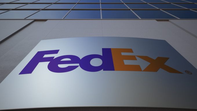 Outdoor signage board with FedEx logo. Modern office building. Editorial 3D rendering